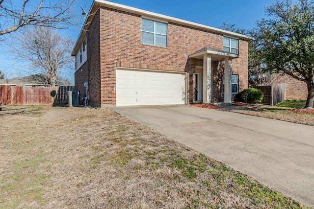 traditional home with driveway, a garage, fence, and brick siding