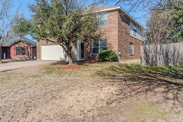 view of front facade with an attached garage, fence, concrete driveway, and brick siding