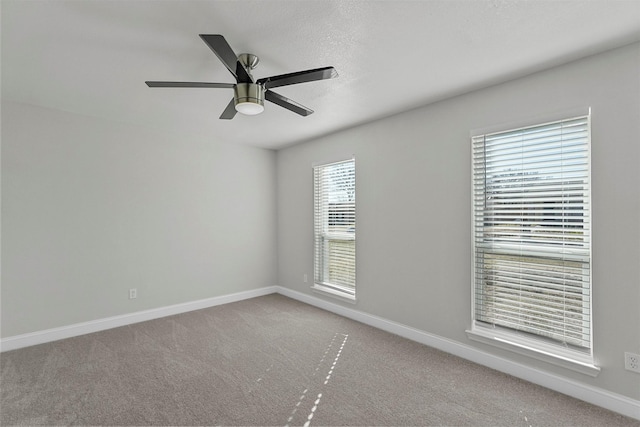 carpeted empty room featuring ceiling fan