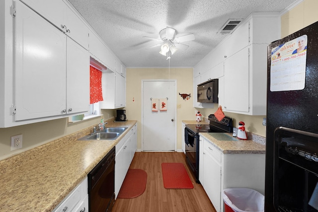 kitchen featuring sink, black appliances, light hardwood / wood-style floors, a textured ceiling, and white cabinets