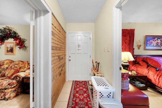 entrance foyer featuring light tile patterned flooring and a textured ceiling