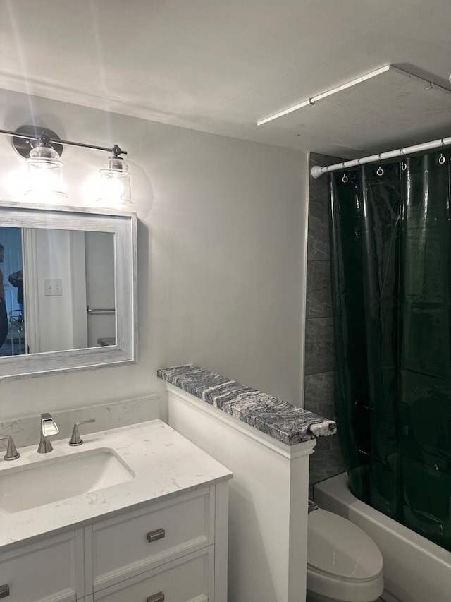 full bathroom with shower / tub combo, vanity, and toilet