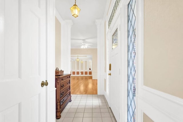 tiled entryway with ornate columns and ceiling fan