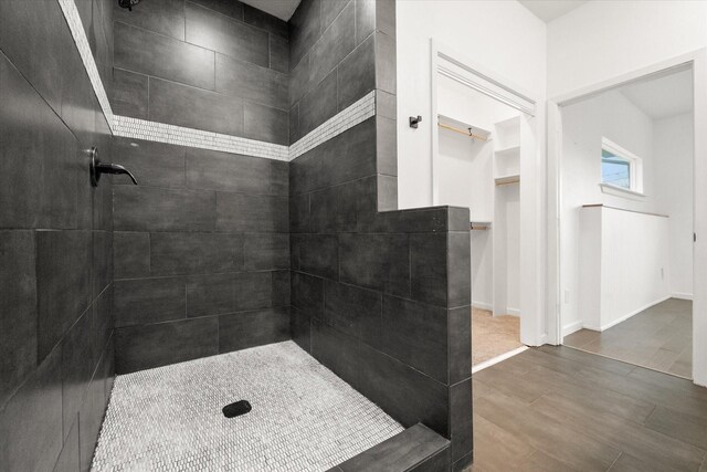 223 S Oak Cliff Blvd, Dallas, TX 75208 - kitchen with glass insert cabinets, tasteful backsplash, light stone counters, light wood-style flooring, and appliances with stainless steel finishes