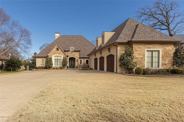 french provincial home with a garage