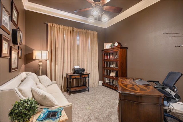 office space with crown molding, ceiling fan, a tray ceiling, and carpet floors