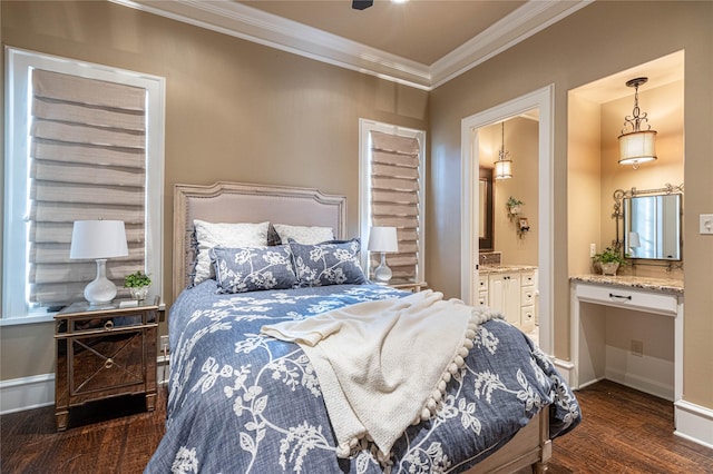 bedroom featuring ornamental molding, dark hardwood / wood-style floors, built in desk, and ensuite bath