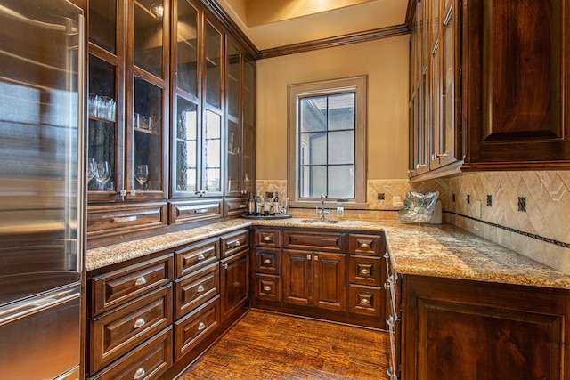 kitchen featuring sink, backsplash, light stone countertops, dark hardwood / wood-style flooring, and high end refrigerator