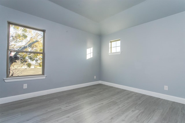 unfurnished room with wood-type flooring