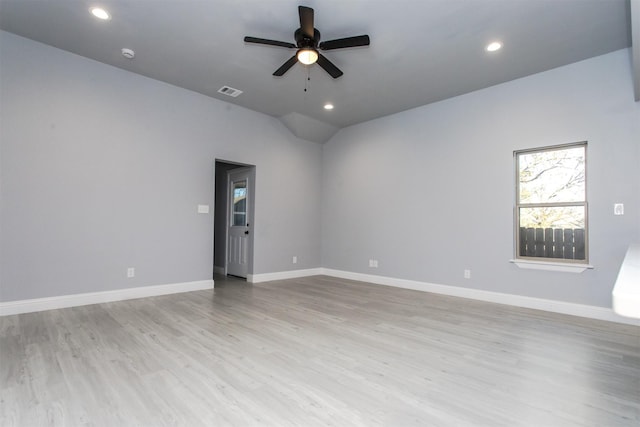 spare room with vaulted ceiling, ceiling fan, and light wood-type flooring