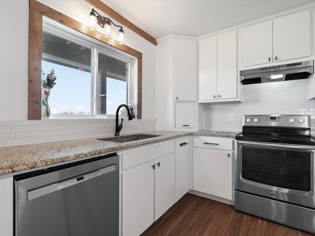 kitchen featuring light stone counters, sink, stainless steel appliances, and white cabinets