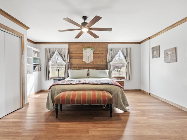 bedroom with multiple windows, ornamental molding, and light hardwood / wood-style floors