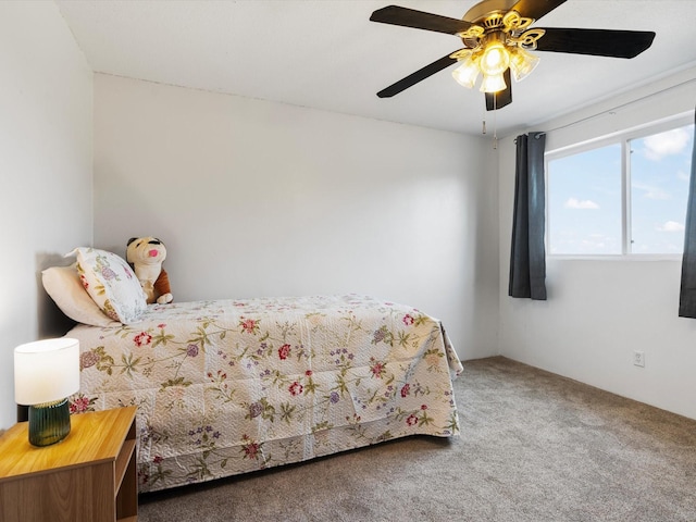 bedroom featuring ceiling fan and carpet