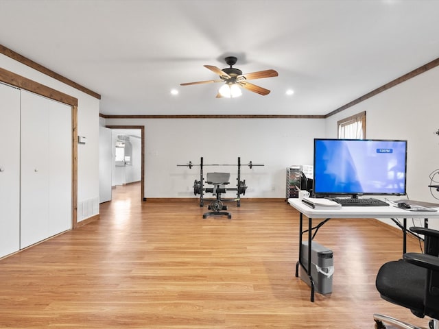 office area featuring ornamental molding, ceiling fan, and light wood-type flooring