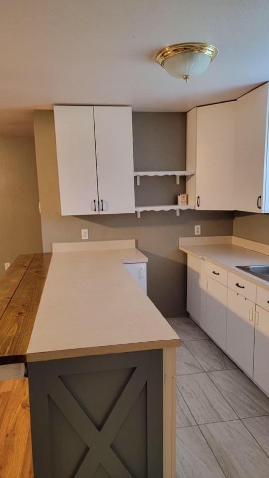 kitchen with white cabinetry and sink