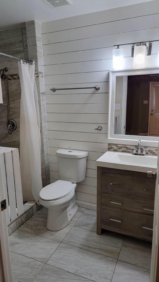 bathroom with radiator heating unit, wooden walls, vanity, toilet, and a shower with curtain