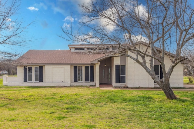 back of property featuring a lawn