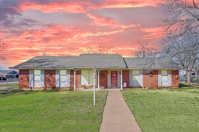 ranch-style house featuring a lawn