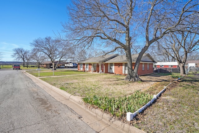 ranch-style home with a front lawn