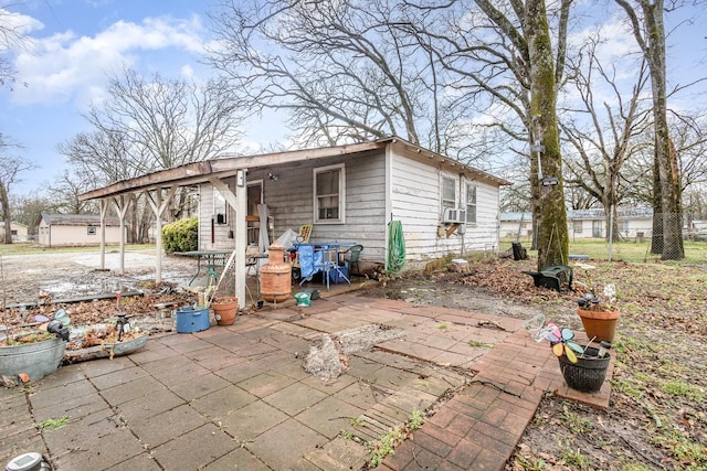 exterior space featuring a patio, cooling unit, fence, and an outdoor structure