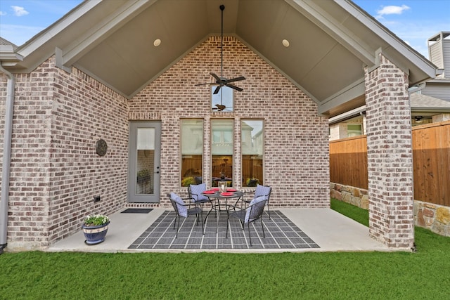 view of patio with ceiling fan and fence