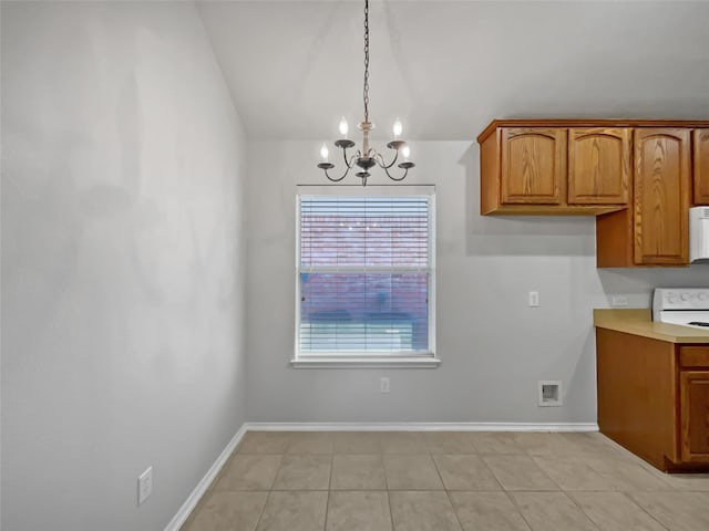 kitchen with pendant lighting, light tile patterned floors, electric stove, a notable chandelier, and vaulted ceiling