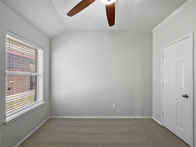 carpeted empty room with ceiling fan and lofted ceiling