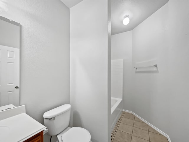 bathroom with vanity, tile patterned flooring, and toilet