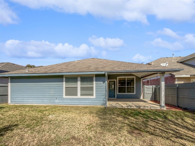 back of house with a yard and a patio area