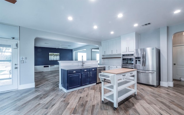 kitchen featuring white cabinetry, sink, a center island, and appliances with stainless steel finishes