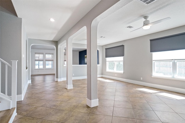 entrance foyer featuring light tile patterned floors, plenty of natural light, and ceiling fan