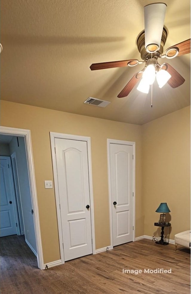 unfurnished bedroom featuring hardwood / wood-style floors and a textured ceiling