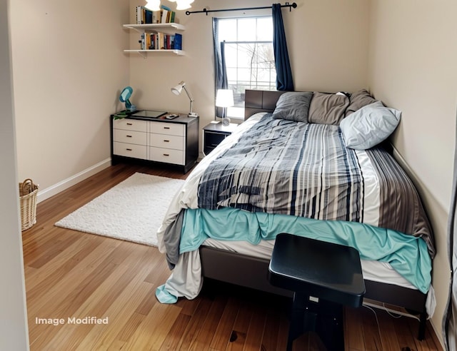 bedroom featuring wood-type flooring