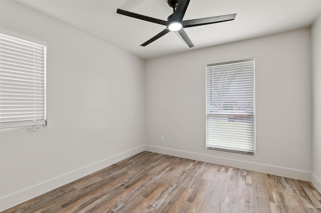 unfurnished room featuring baseboards, ceiling fan, and light wood finished floors