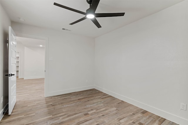 unfurnished room with visible vents, baseboards, light wood finished floors, and ceiling fan