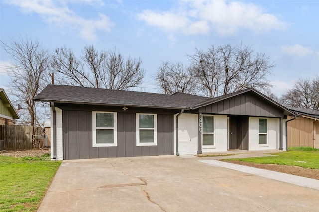 ranch-style house featuring brick siding, roof with shingles, and fence