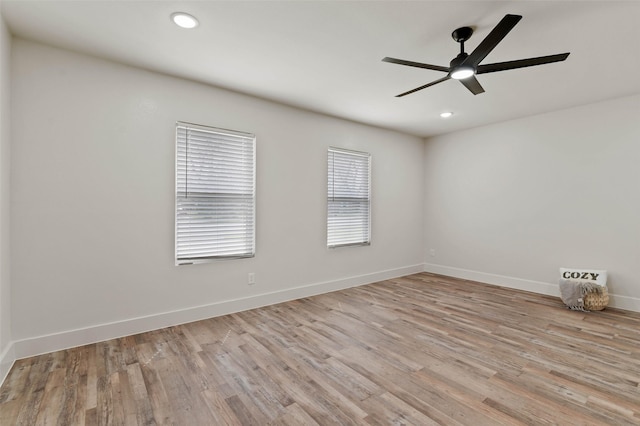 spare room featuring recessed lighting, baseboards, light wood finished floors, and ceiling fan