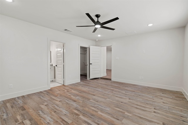 unfurnished bedroom with light wood-type flooring, visible vents, ensuite bath, recessed lighting, and baseboards