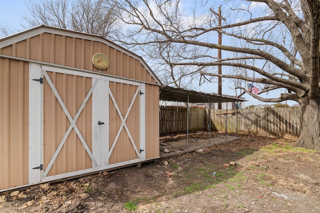 view of shed featuring fence