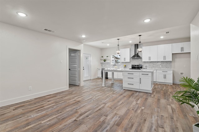 kitchen featuring open shelves, visible vents, decorative backsplash, and wall chimney range hood