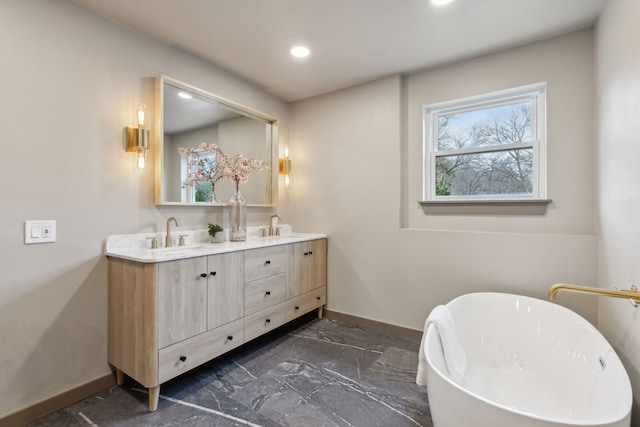 bathroom with vanity and a bath