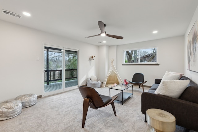 carpeted living room with plenty of natural light and ceiling fan