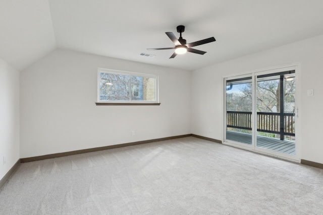 empty room with light carpet, a wealth of natural light, and ceiling fan