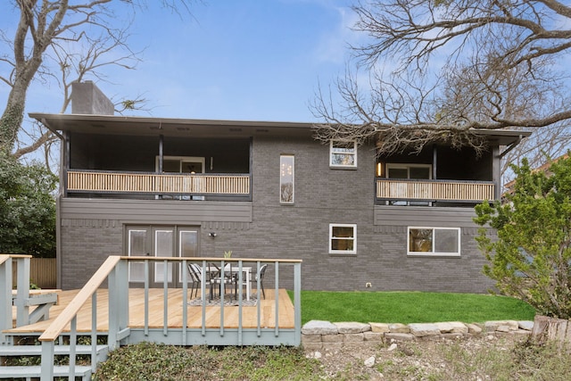 back of property featuring a balcony and a deck