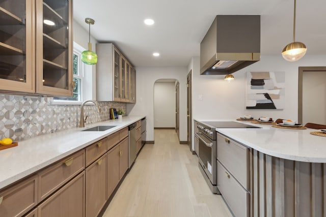 kitchen featuring hanging light fixtures, stainless steel appliances, sink, and wall chimney exhaust hood