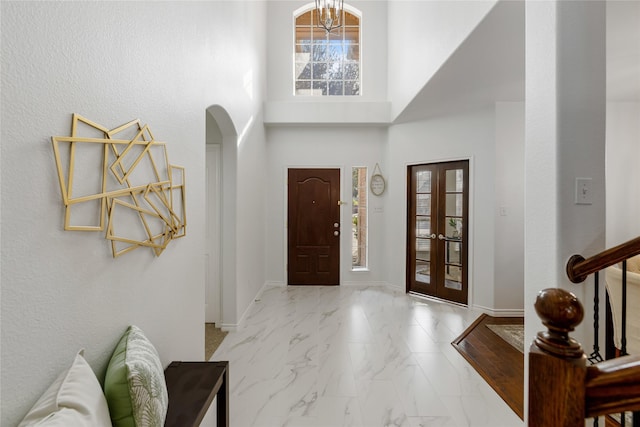 entrance foyer featuring a notable chandelier and a high ceiling