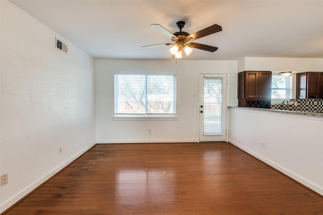 interior space featuring dark hardwood / wood-style flooring, sink, and ceiling fan