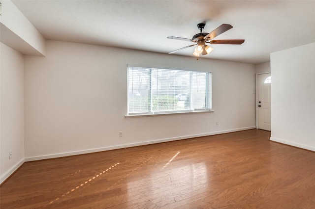 spare room featuring hardwood / wood-style floors and ceiling fan