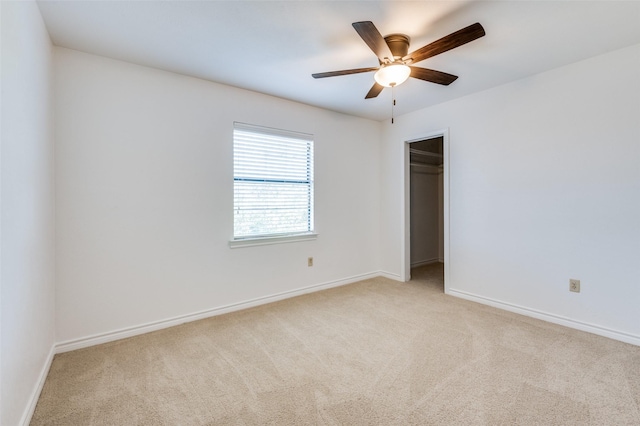 unfurnished bedroom with light carpet, a closet, and ceiling fan