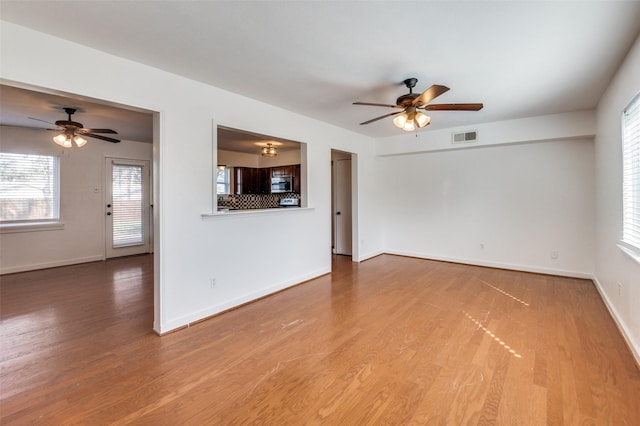 unfurnished living room featuring hardwood / wood-style flooring and ceiling fan